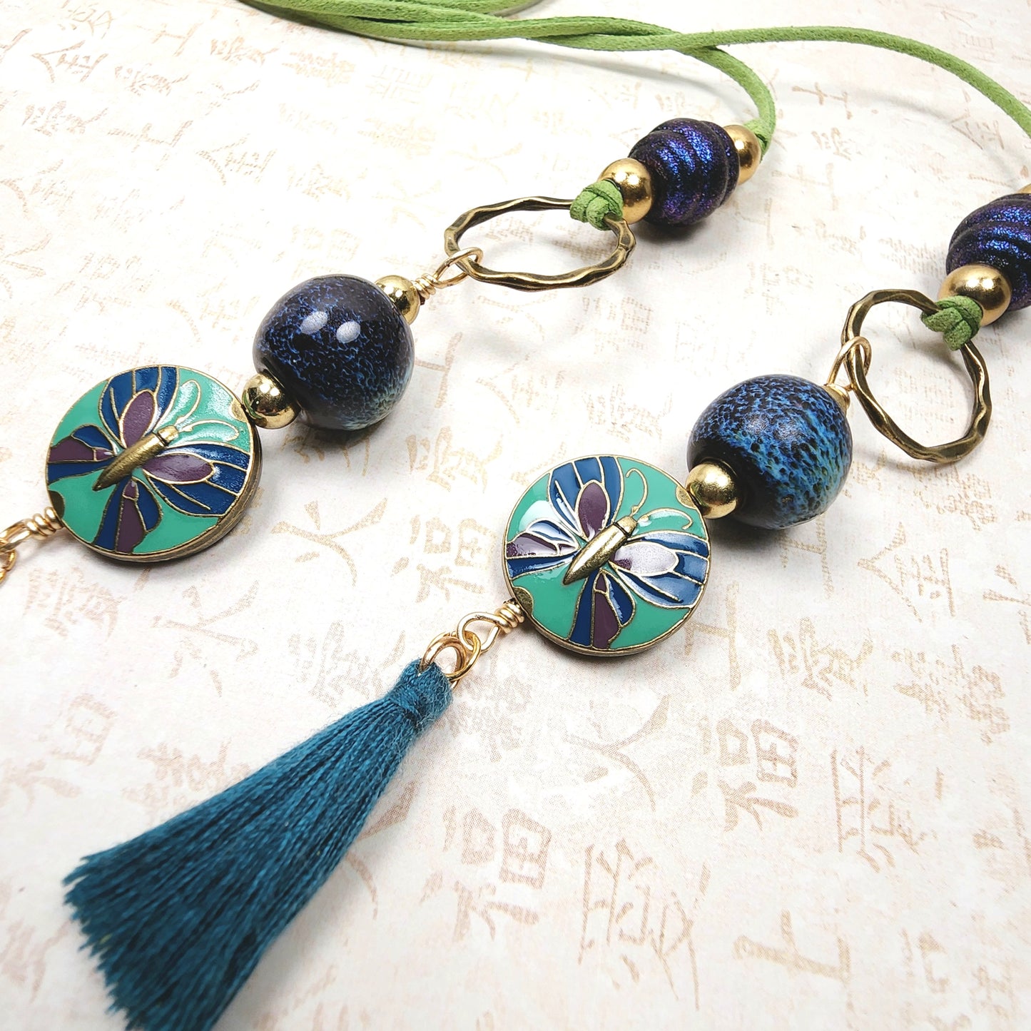 Boho Butterfly Necklace – Handmade Jewelry with Brass Coin Beads, Blue Ceramic, Teal Tassel & Green Faux Suede Cord