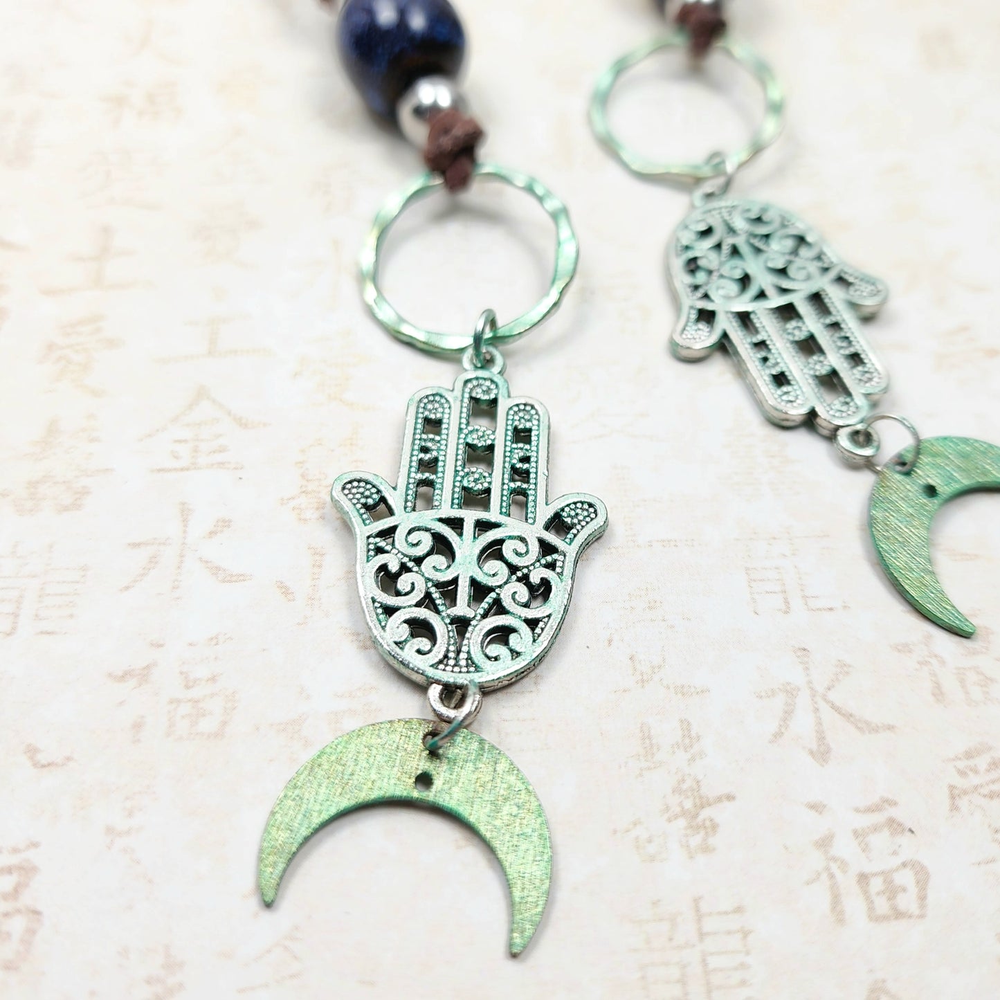 Boho Hamsa & Moon Necklace – Handmade Jewelry with Silver Hamsa Charm, Blue Ceramic Beads, Brass Rings & Faux Suede Brown Cord