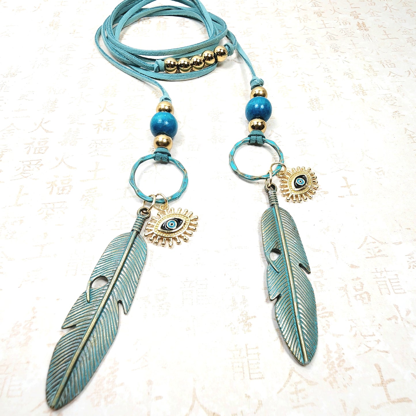 Boho Evil Eye Feather Necklace – Handmade Jewelry with Brass Feathers, Teal Wood Beads, Golden Accents & Faux Suede Cord