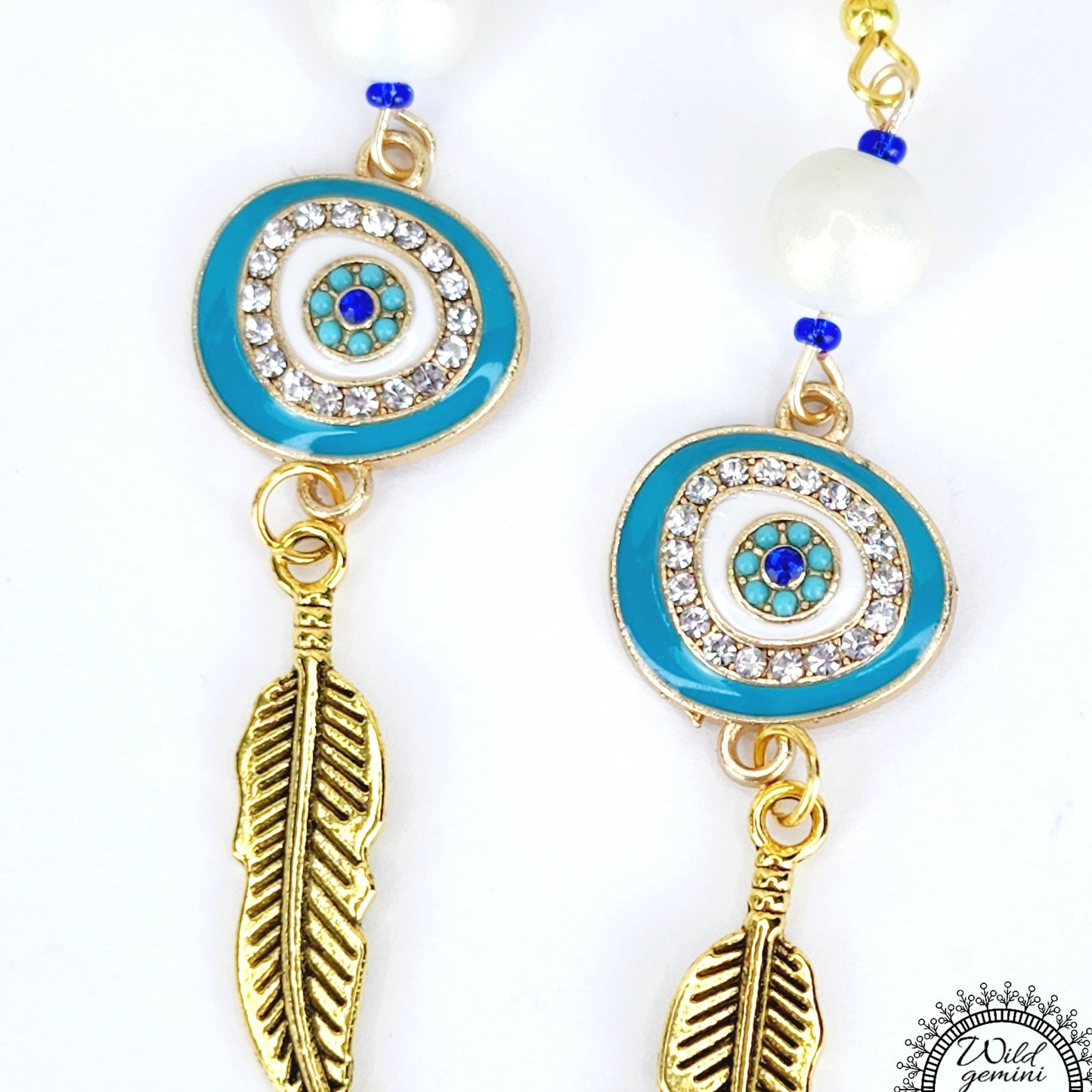 Boho Evil Eye Feather Earrings – Handmade Gold Dangles with White Glass Beads, Rhinestone Charms & Gold Feathers, 3” Long