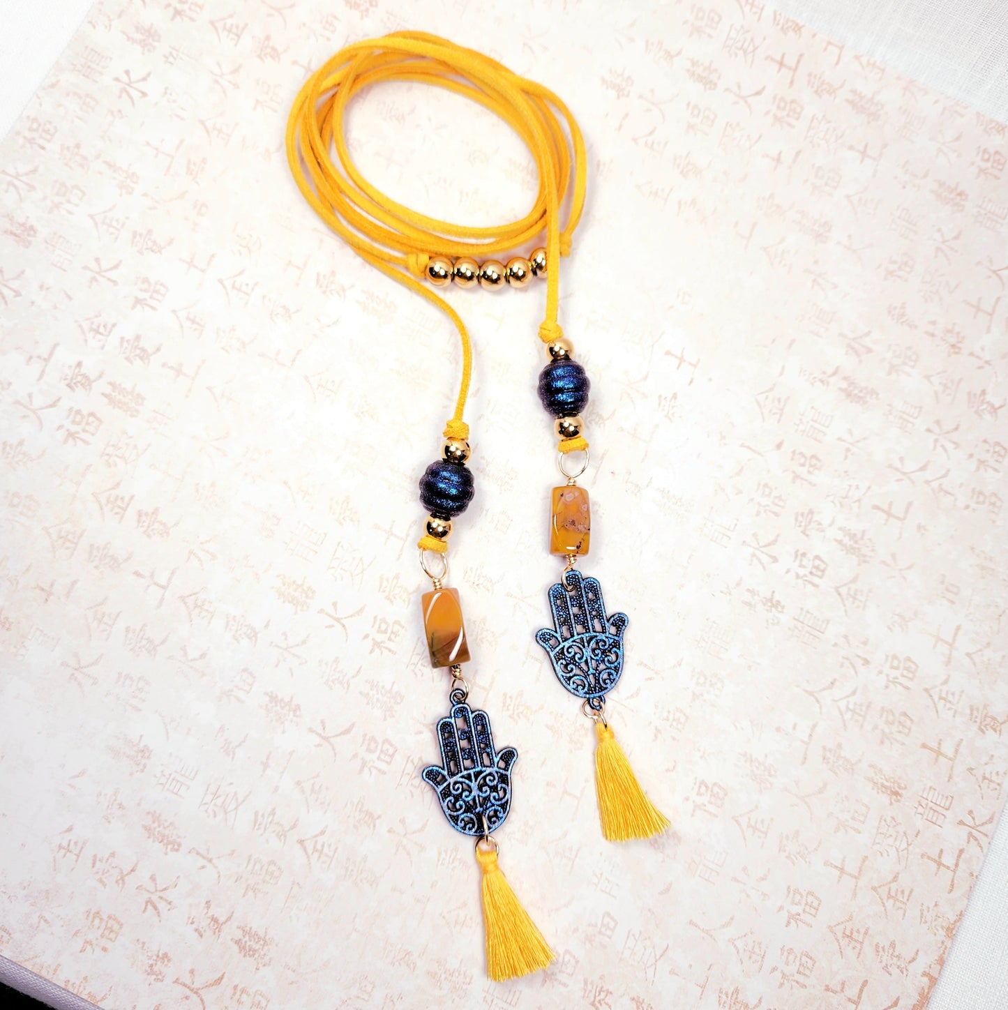 Boho Hamsa Hand Necklace – Handmade Jewelry with Blue Hamsa Charm, Yellow Jasper, Golden Beads & Tassel on Faux Suede Brown Cord