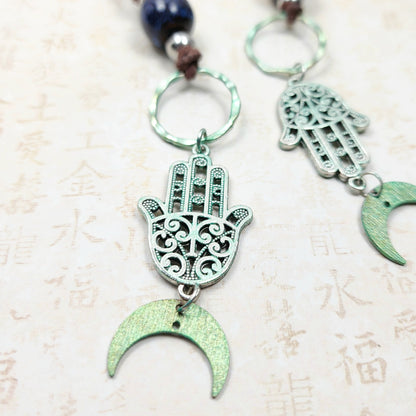 Boho Hamsa & Moon Necklace – Handmade Jewelry with Silver Hamsa Charm, Blue Ceramic Beads, Brass Rings & Faux Suede Brown Cord