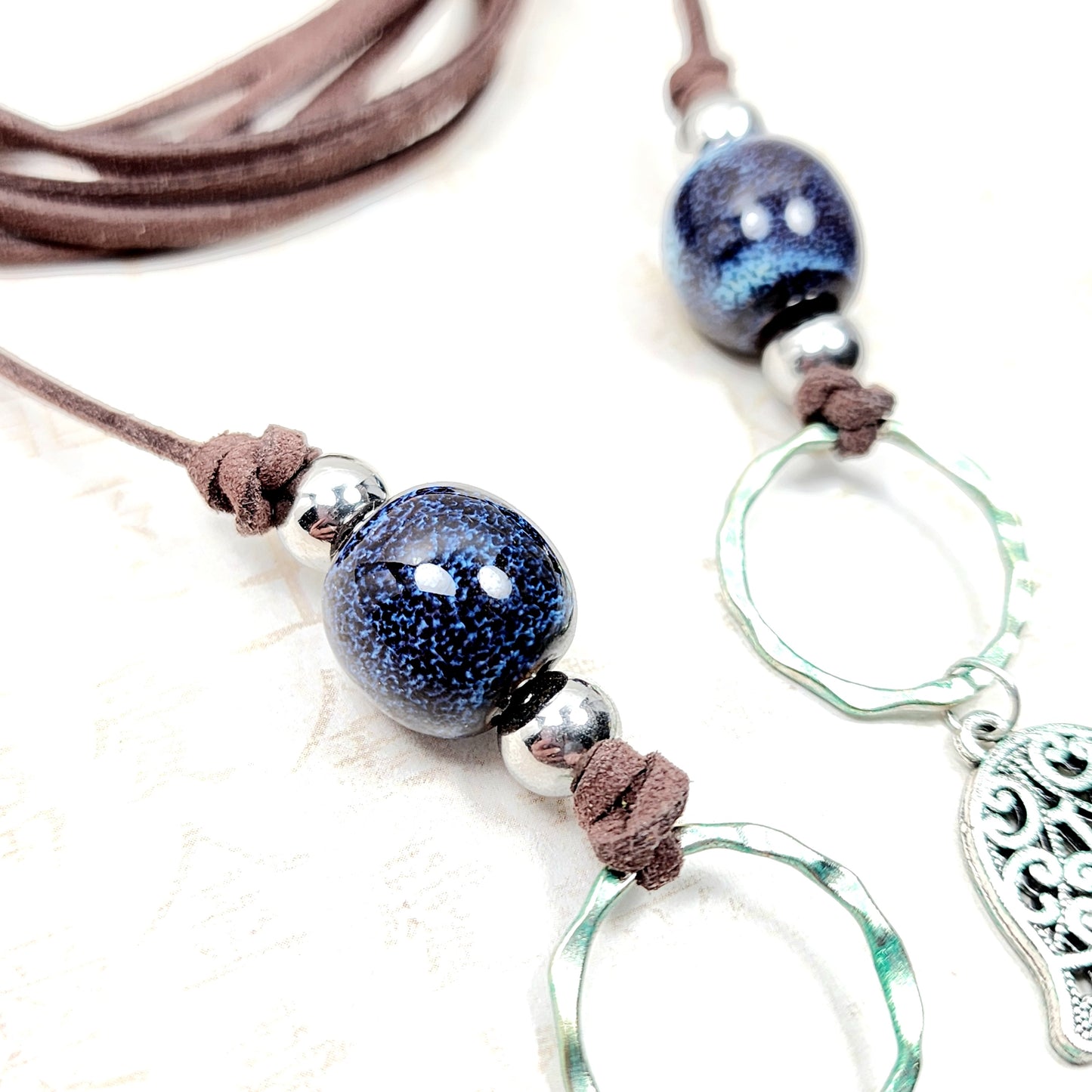 Boho Hamsa & Moon Necklace – Handmade Jewelry with Silver Hamsa Charm, Blue Ceramic Beads, Brass Rings & Faux Suede Brown Cord