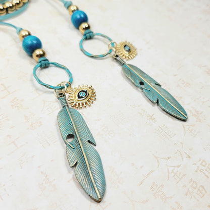 Boho Evil Eye Feather Necklace – Handmade Jewelry with Brass Feathers, Teal Wood Beads, Golden Accents & Faux Suede Cord