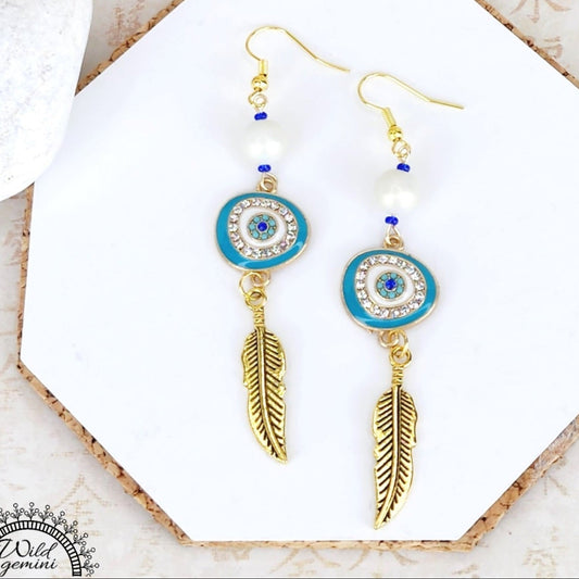 Boho Evil Eye Feather Earrings – Handmade Gold Dangles with White Glass Beads, Rhinestone Charms & Gold Feathers, 3” Long